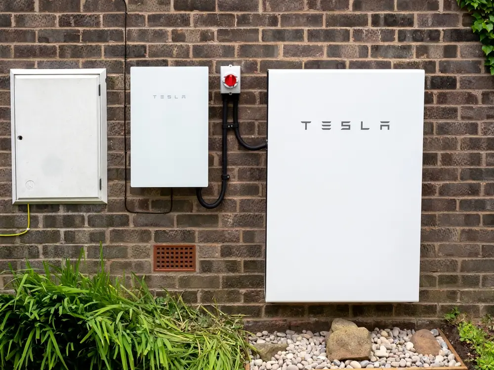 Tesla Powerwall 2 and Backup Gateway 2 installed on a brick house wall