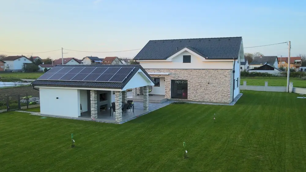 Aerial of modern smart home with solar panel installed on rooftop, house in residential districts futuristic safe neighborhood